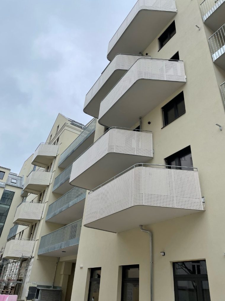 Balkone mit Geländern aus Lochblech an einem Wohnbau